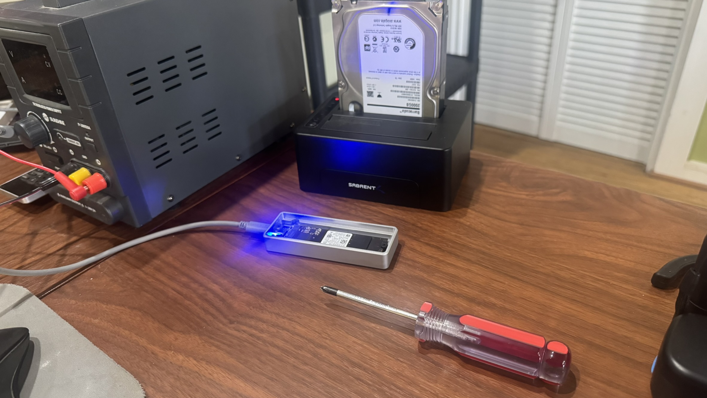 Technician prepping an NVMe SSD for data migration and drive cloning from HDD in dock at MyTown Computer Service in Mt. Pleasant MI.
