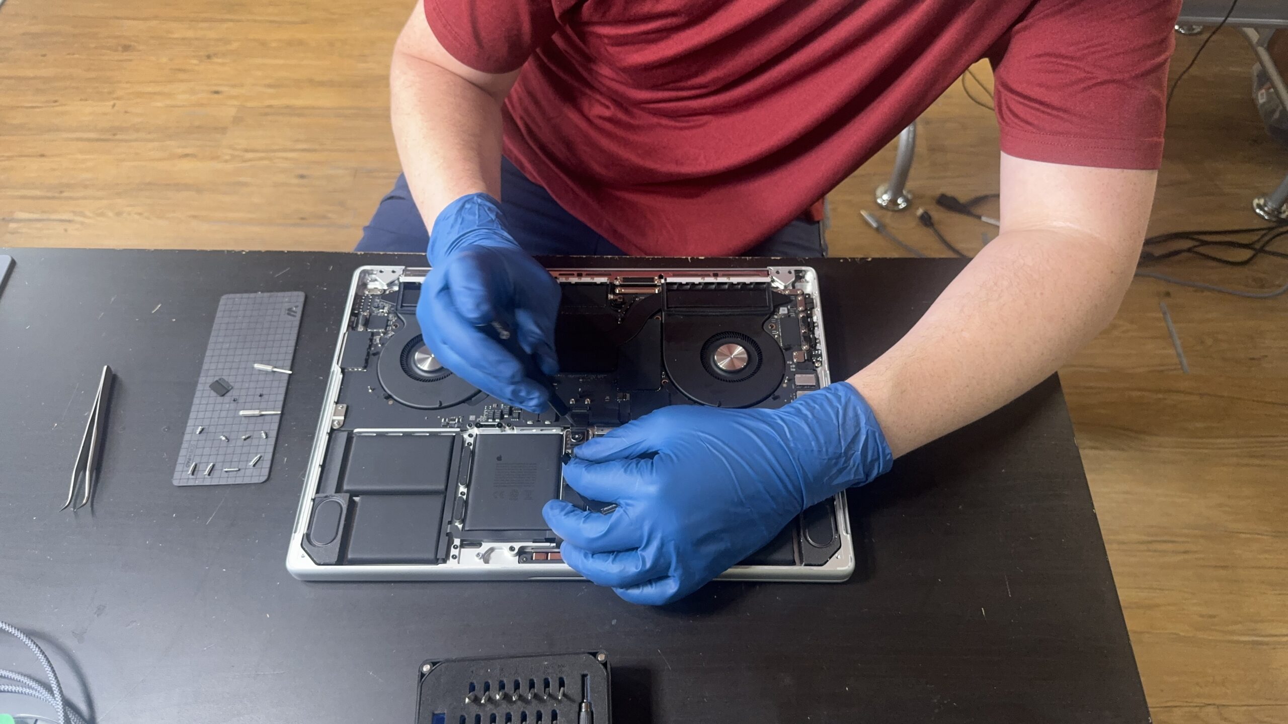 Technician diagnosing MacBook hardware issues in Mt. Pleasant, MI